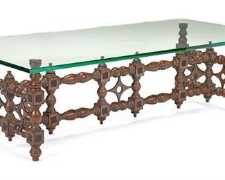 2067
A Moroccan-Style Rectangular Carved Wood Cocktail Table
Circa 1960
The rectangular table with glass top resting on turned wood body with carved diamond decorated stretcher and ornamental metal medallions
17.5" H x 59" W x 30" D
Estimate: $400 - $600