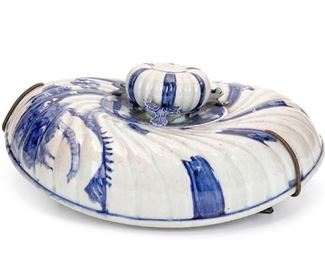 2087
A Blue And White Porcelain Lid
19th/20th Century
Likely Chinese or Japanese, the asymmetric ovoid lid with applied foliate details
15" H x 14.25" W x 5.125" D; Overall: 15" H x 14.25" W x 6.5" D
Estimate: $300 - $500