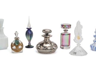 2089
Seven Perfume Bottles
First-half 20th Century
One initialed and numbered indistinctly to base
Various styles including one opaline blue and purple, one squat form with silver overlay, and one multicolored striped glass, 7 pieces
Tallest: 7" H x 3.875" Dia.
Estimate: $300 - $400