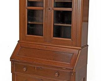 2092
A Walnut Drop Front Secretary Bookcase
Fourth-quarter 19th Century
The glazed two-door cabinet enclosing two shelves over a drop front desk with slide out supports and fitted with five drawers, six pigeonholes, and a green felt writing panel over three drawers atop a shaped apron raised on bracket feet
81.25" H x 39" W x 18" D
Estimate: $600 - $900