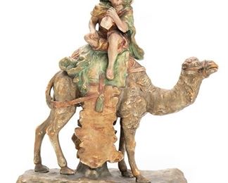 2126
An Amphora Figure Of A Man On A Camel
Circa 1905-1910; Teplitz, Austria
Marked for Amphora Works Turn / Amphora Riessner & Kessel Turn-Teplitz: [Crown] / Amphora / Austria / 8244 / 29
The Middle-Eastern figure depicted drinking from a jug on a camel
12.75" H x 13" W x 4" D
Estimate: $300 - $500