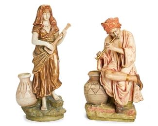 2127
Two Amphora Pottery Musicians
Circa 1905-1910; Teplitz, Austria
Each marked for Amphora Works Turn / Amphora Riessner & Kessel Turn-Teplitz: [Crown] / Amphora / Austria; Each numbered
Comprising a male figure with a flute (#4934 / 48) and a female figure playing a lute (#4929 / 51), each next to a small pot, 2 pieces
Male: 13.5" H x 7.5" W x 6.25" D; Female: 14.5" H x 6" W x 4.5" D
Estimate: $400 - $600