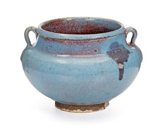 2132
A Chinese Two-Handled Glazed Earthenware Bowl
Late Qing Period (19th Century)
The wide-rimmed bowl with a fluted neck flanked by two loop handles with a thick light blue and midnight blue glaze
4.5" H x 6.5" Dia.
Estimate: $300 - $500