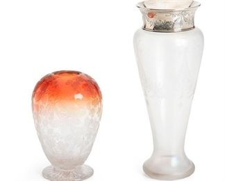 2156
Two Etched Glass Vases
Late 19th/early 20th Century
Glass unmarked; Sterling marked for Gorham
Comprising one Stueben Verre de Soie baluster-form vase with etched bow and swag decoration and a Gorham sterling silver rim with matching designs (11" H x 4.5" Dia.) and one St. Louis egg-shaped rubina glass vase decorated by Moser with overall acid etched berry and leaf decoration on a circular clear cut glass base (6.5" H x 4.5" Dia.), 2 pieces
Estimate: $500 - $700
