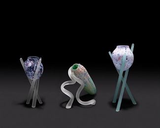 2164
Three Multicolor Glass Vases On Pedestals
Fourth-quarter 20th Century
Apparently unmarked
Comprising two purple and multicolor glass vases on tripod bases together with a sideways-leaning green and multicolor vase on two spiraled supports, 3 pieces
Tallest: 17.25" H x 9" Dia.
Estimate: $200 - $300