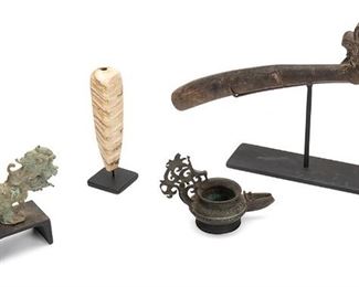 2183
Four Indonesian Items
20th Century and earlier
Comprising an adze with an ornamented carved handle, a banded stone cigarette holder, a bronze lamp with a reticulated handle, and a zoomorphic bronze finial in the form of a creature with a lion head at one end dated circa 900-1100 CE, 4 pieces
Largest: 13.5" H x 7.25" W x 2.5" D; Overall: 9.5" H x 7.25" W x 2.5" D
Estimate: $300 - $500