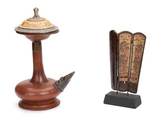 2184
Balinese "Kendi" Holy Water Bottle And "Kotak Taji" Cockspur Case
20th Century; Bali, Indonesia
Comprising a ceramic holy water bottle with footed base, elongated neck, ornamented metal spout, and polychromed wood lid with a gemstone-set finial and a tri-folding cockspur case with painted figural scenes on metal mount, 2 pieces
Larger: 10.25" H x 6.5" W x 5" D
Estimate: $300 - $500