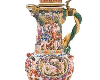 2208
An Italian Capodimonte Ewer
First-quarter 20th Century
Blue underglazed mark to the bottom
The hinged lid over a molded body adorned with Neoclassical figures
17.25" H x 9.5" W x 7.5" D
Estimate: $200 - $400