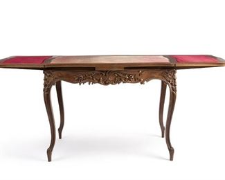 2226
A Louis XV-Style Carved Wood Extendable Table
19th Century
Apparently unmarked
The extending sides pop up flush with central red velvet top, with flower and acanthus leaf carvings to the sides and cabriole legs on scroll and peg feet
Closed: 29" H x 39.375" W x 24" D; Extended: 29" H x 67.5" W x 24" D
Estimate: $800 - $1,200