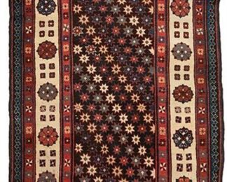 2236
A Caucasian Area Rug
First-half 20th Century
Wool on wool foundation, with polychrome geometric star and floral patterning on dark field with ivory, red, and blue borders
79" L x 40" W
Estimate: $500 - $700