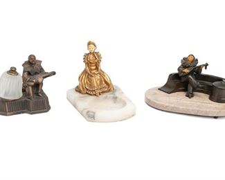 2282
Three Figural Marble And Patinated Metal Objects
Late 19th/early 20th Century
Unmarked
Comprising an oval pen tray and inkwell with seated bard on small feet, a desk dish with seated gilt-bronze lady and round shallow bowl, and a small lamp with seated bard and frosted glass shade, 3 pieces
Pen tray: 5.25" H x 11" W x 7.25" D
Estimate: $300 - $500