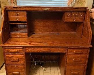 Winners Only Inc. roll top oak wood desk. This is a very nice desk with lots of drawers, drop front drawer for keyboard, and includes keys.