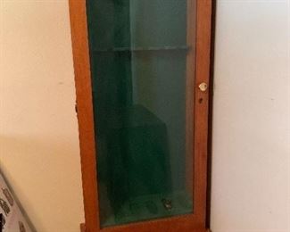 Wood gun case with glass front, 6 gun slots, and two drawers. Cabinet measures 26 x 12 x 70. Lock with key included. 