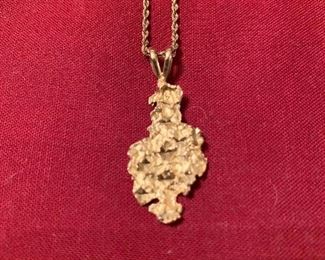 14 karat nugget pendant on a 20 inch chain. Weighs 5.5 g. 
