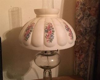 Appears to be a kerosene lamp that has been made
into an electric lamp. Comes with glass globe and measures 11 in round and 21 in tall.
