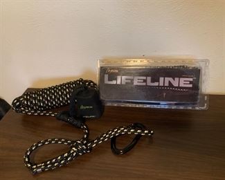 Two new Lifeline tree stand safety devices. One
comes in packaging. Connects to tree to ensure safe hunting.
