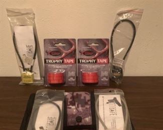 This lot includes 3 Project Childsafe locks, 1 tri star lock, 1 Ameristep pouch, and 2 new rolls of trophy tape.