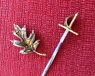 $20  Sword pin and  $10 leaf pin.  Sword: 4.5" L, 1.5" W.  Leaf: 2.5" L, 1.5" W.  