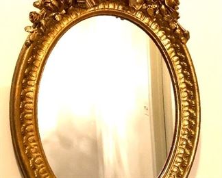 $180  Oval gilt mirro with bow and floral border 