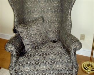 One of a pair custom upholstered wingback chairs.
