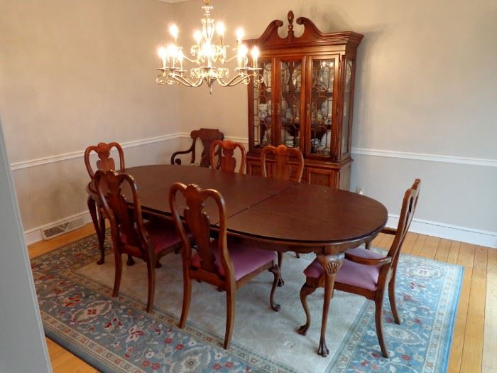 American Drew Cherry dining room suite. Includes table with two extension leaves, six chairs and Dansk pads and cherry Federal style china cabinet.