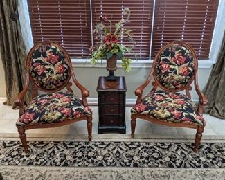 Cherry round back accent arm chair. Upholstered with red lily print on black background. Coordinating silk floral accent. Narrow 3 drawer occasional table.