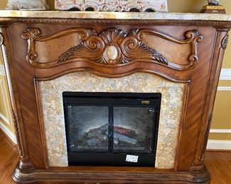 Original signature series Michael Amini by Aico well crafted electric fireplace with sold top granite as well as the door side completed look of granite. 
4000.00 OBO 