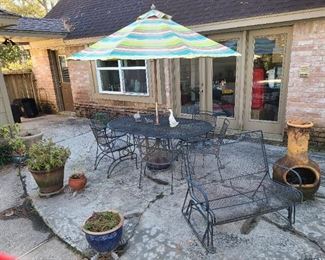 6 chair wrought-iron poolside table w/matching slider bench included with Pier One umbrella