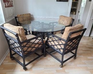 Vintage rattan table set with rolling chairs 