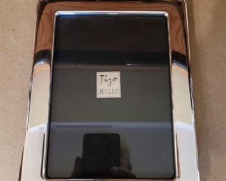 One of a dozen Sterling Silver photo frames, most made by TIZO, and retail from 225-300 each!