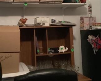 A desk with desk chair and a few of the records available.