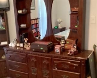 The dresser that goes with the bedroom suite with round mirrors and side shelves.