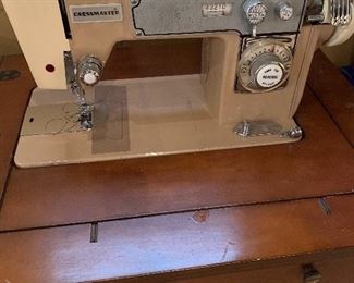 Dress master sewing machine in cabinet