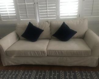 $650 -- Pottery Barn sueded synthetic slip covered sofa.  Excellent condition.  Length 7.5' x depth 42" x height 32".  