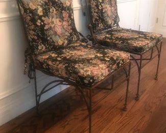 $250 Pair -- Wrought iron indoor/outdoor side chairs.  Quality construction with tie-back floral pads.  Excellent condition from indoor use.  Height 40" x depth 22".  