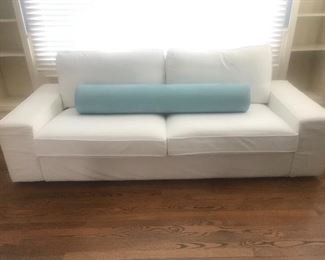 $325 -- Ikea  white "Kivik" slip covered sofa.  Cotton twill slip covers need cleaning,  otherwise in excellent condition.   Length 90"x  depth 36"x height 32".  Blue West Elm bolster pillow $60.  