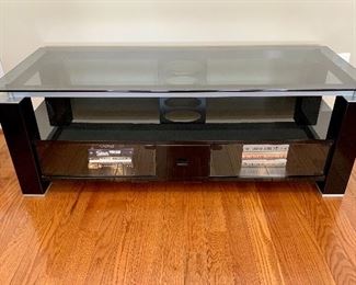 $295 - Contemporary Glass top media table  with one drawer and two storage compartments (magnet on right compartment needs small repair). 20"H x 56"W x 22"D