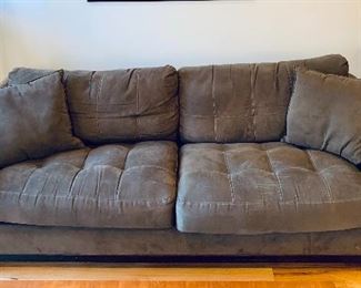 $350 - H.M. Richards tufted two cushion chocolate upholstered sleeper sofa.  28"H x 89"W x 38"D (seat height 19.5"H).  Some wear on right arm.