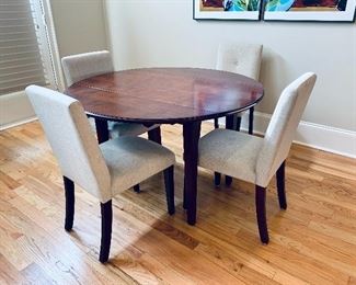 $425 - O-Palier drop leaf round wood table with set of four  upholstered linen chairs with button back  (some spot cleaning required).  Table: 30.25"H x 50"D with leaves up (23.5"W with leaves down).  Chairs: 36"H x 16.5"W x 20"D (seat height 19"H)