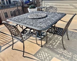 $575 - Cast aluminum outdoor table with 8 chairs (4 not photographed); 61” square x 29” H; 24” lazy susan; Chairs approx 36”H x 24”W x 21”D.  Seat height 16”