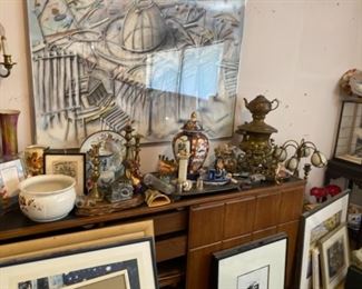 Framed Artwork, Vintage Bowl and Dishes, Bronze Tea Pot, Vintage Lamp, Vintage Candlestick Holders, Vase with Lid, Wooden Dresser, and Various Vintage Items