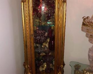 3 different golden curio cabinets