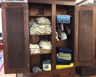 Tall armoire with tapered dovetail joints holding all parts together.  Breaks down into three pieces for easy moving. Signed by maker in several places.