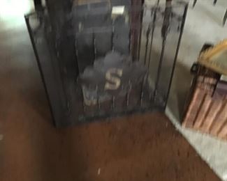 Black metal fire screen with monogram S.