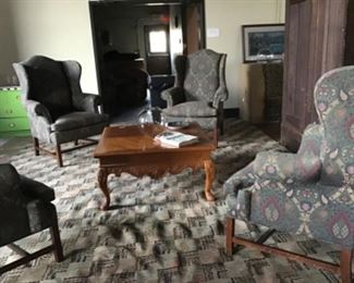 Four large wing chairs on 1920’s rug.  Rug is in great condition and is very large.