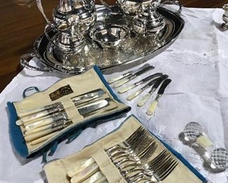 Sterling forks, butter spreaders, and knives with mother of pearl handles.  Excellent condition. 