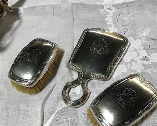 Sterling man’s dresser set with two brushes and hand mirror.