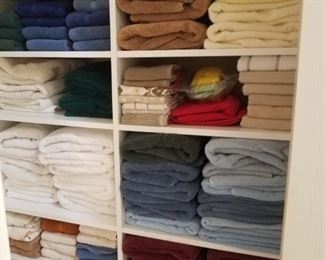 Linen closet is packed with nice quality linens. 