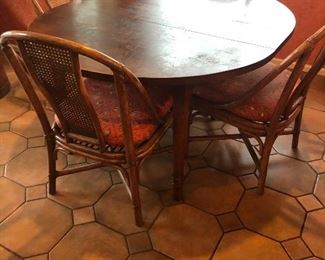Antique round table with 6 rattan and cane chairs. 47" diameter x 29"h. Also has a 10" leaf to create an oval 57"l x 47"wide. $380