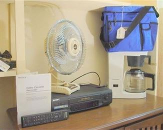 36. Shelf Lot with Sony Video Cassette , Coffee Maker, Tabletop Fan, Carry Cooler